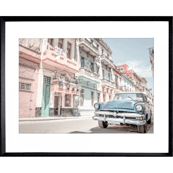 Black Framed Wanderlust Wall Art - Havana 01 Studio Collection. Featuring a classic Havana street landscape in soft pink, blue and aqua tones and with a pale blue sunny skyline in the background