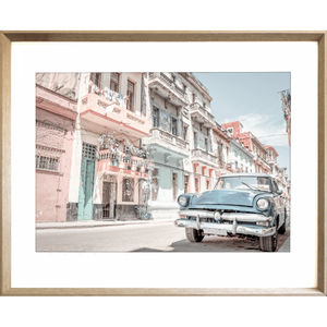 Gold Framed Wanderlust Wall Art - Havana 01 Studio Collection. Featuring a classic Havana street landscape in soft pink, blue and aqua tones and with a pale blue sunny skyline in the background