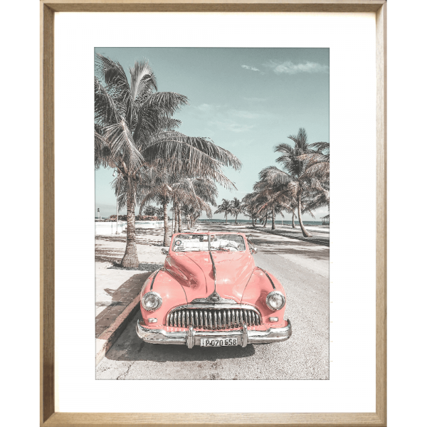 Gold framed Wanderlust Wall Art - Havana 02 - Studio Collection, featuring a pink dodge car travelling down the Palm coastline.