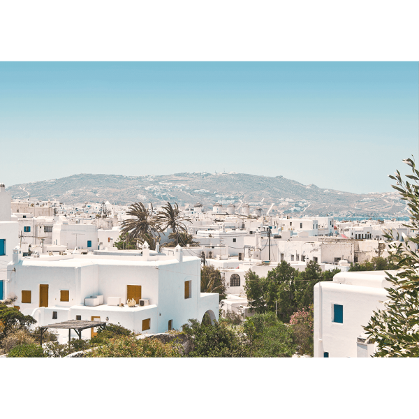 Coastal Wall Art featuring white coastal buildings against a backdrop of similar white building, rolling hills and blue skyline on canvas