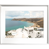 Silver framed Modern coastal wall art featuring  crisp white buildings against a backdrop of the crystal blue ocean