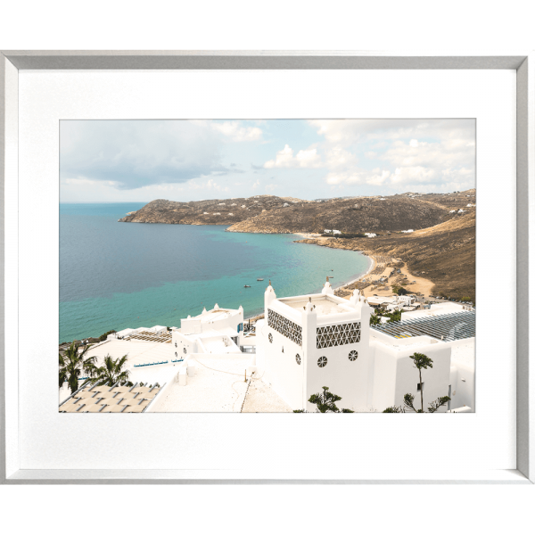 Silver framed Modern coastal wall art featuring  crisp white buildings against a backdrop of the crystal blue ocean