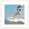 White framed Nautical Wall Art, featuring a single crisp white sailing ship floating on a pristine sky-blue ocean, against a pale blue skyline