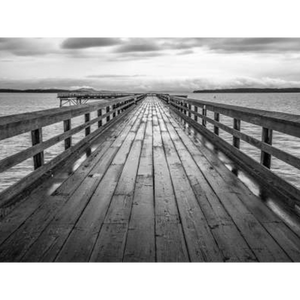 Black and white wall art features a long pier cascading into the deep ocean, with an array of white clouds overhead on canvas