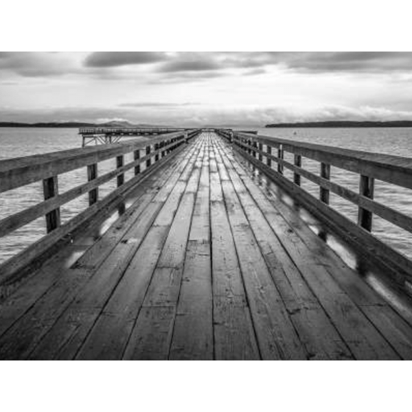 Black and white wall art features a long pier cascading into the deep ocean, with an array of white clouds overhead on canvas