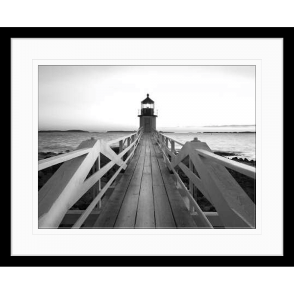 Black and white wall art features a single pier cascading into the deep ocean, culminating at a light house in a black frame