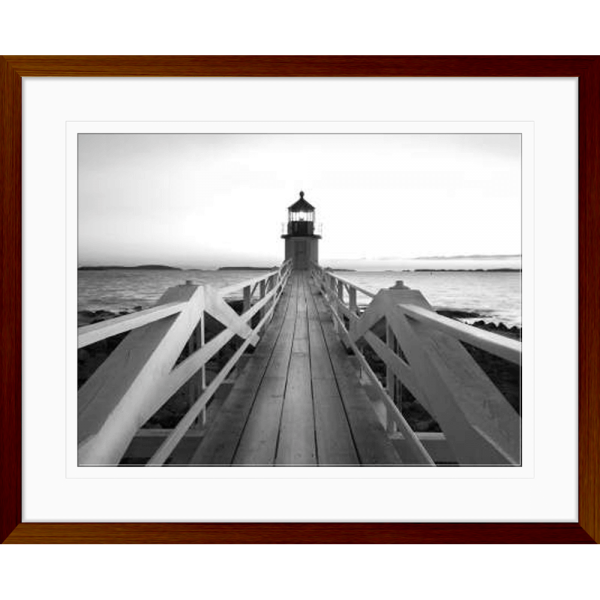 Black and white wall art features a single pier cascading into the deep ocean, culminating at a light house in a wood grainframe