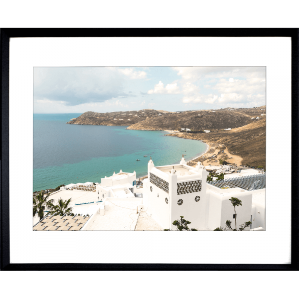 Black framed Modern coastal wall art featuring  crisp white buildings against a backdrop of the crystal blue ocean